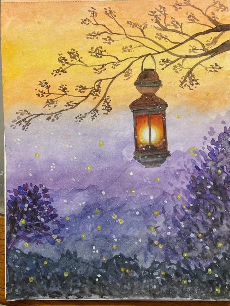 A lantern hangs from a flowering branch, glowing warm orange over a field of lavender scattered with fireflies, beneath an amber dusk sky.