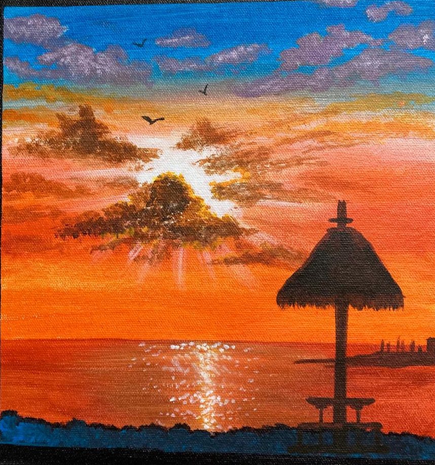 A thatched tiki umbrella in silhouette against a blazing orange sunset over water, the sun breaking through violet clouds.